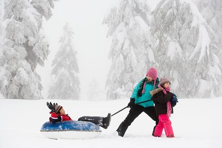 Stock photo of three children playing in the snow